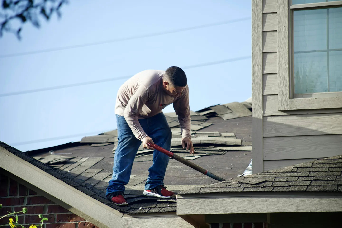 Shingle removal on a Sugar Land home; representative roof replacement process